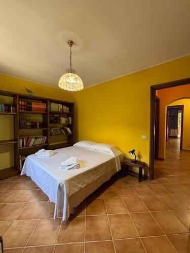 a bedroom with a bed and a yellow wall at Casa vacanze Selene in Bolsena