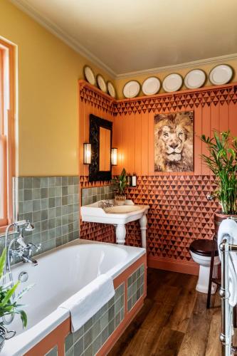 a bathroom with a tub and a sink at The Loch Lomond Arms Hotel in Luss