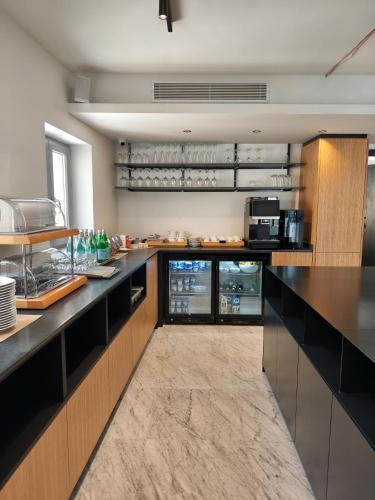 a large kitchen with black counter tops and appliances at Ursulino Valletta in Valletta