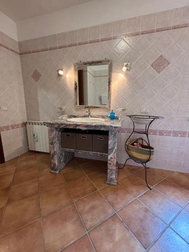 a bathroom with a sink and a mirror at Casa vacanze Selene in Bolsena