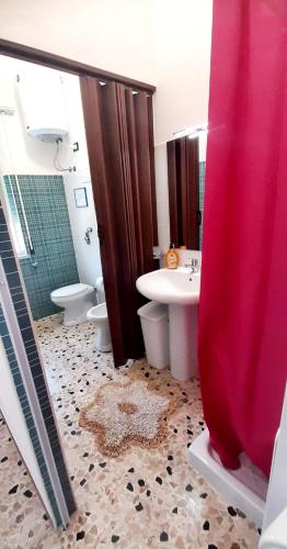 a bathroom with a sink and a toilet and a shower at The house of the islands Sea view in Marausa