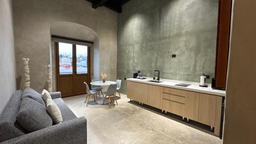 a kitchen with a couch and a sink and a table at Casa 1800 Oaxaca Boutique Hotel in Oaxaca City