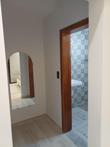 a bathroom with a mirror and a shower at Dar Aalya in Djerba