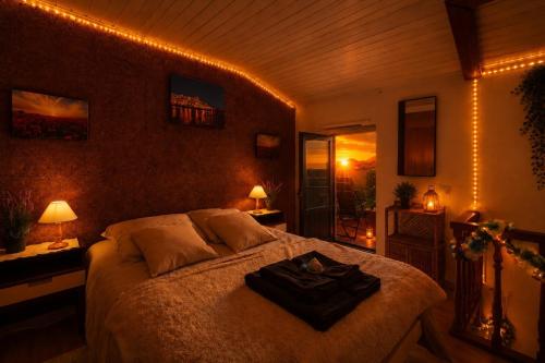 a bedroom with a bed with a black robe on it at Casa sol e mar in Colares