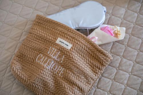 a brown purse sitting on top of a bed at Villa Calliope Lardos in Lartos