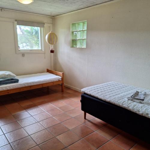 a bedroom with two beds and a window at Spacious Villa near Gothenburg in Alingsås