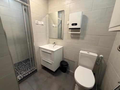 a bathroom with a toilet and a sink and a shower at L'Escapade Normande in Caen