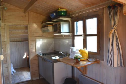 a small kitchen with a sink and a window at Gite foret landaise in Sainte-Eulalie-en-Born