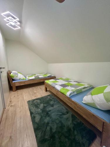a room with two beds and a rug at Blockhaus Wassermann Spielberg in Spielberg