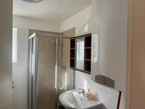 a bathroom with a sink and a shower at Blockhaus Wassermann Spielberg in Spielberg