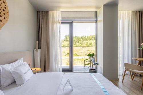 a hotel room with a bed and a large window at WOL 07 by Ribas in Bukovel