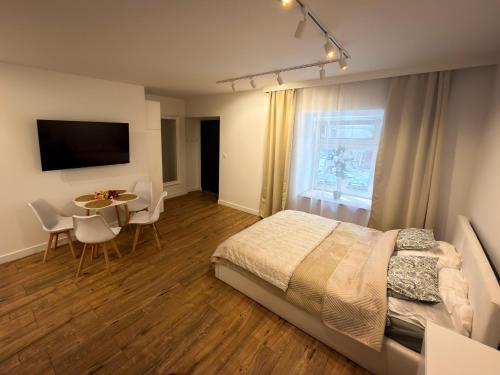 a bedroom with a bed and a table with chairs at Furman's Court in Lublin