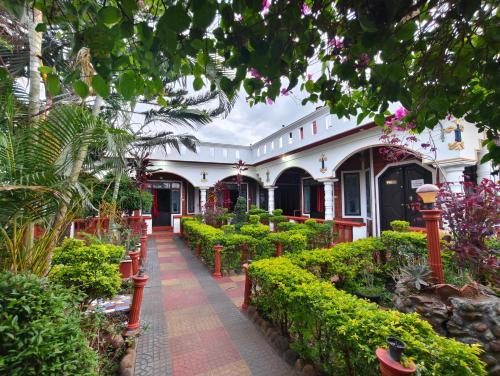 a garden in a building with plants and trees at Red Stone villa in Masinagudi