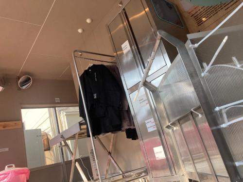 a dressing room with a mirror and a rack at 8月1日オープン クリエイターズinn 宇野港近い トイレ風呂部屋にあり Uno collage in Tamano