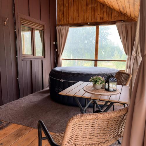 a room with a table and a large tire at Little H Family in Dealu Mare