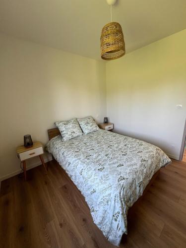 a bedroom with a bed with a white comforter at Logement en campagne in Bédarrides