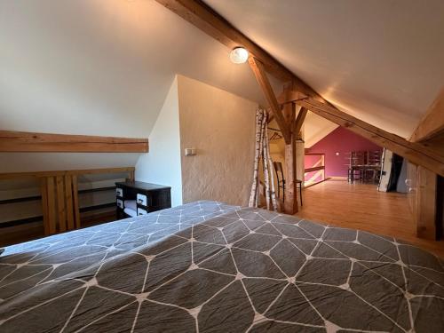 a bedroom with a bed in a attic at Cozy Cottage - Authentic apartment in Mullerthal in Waldbillig