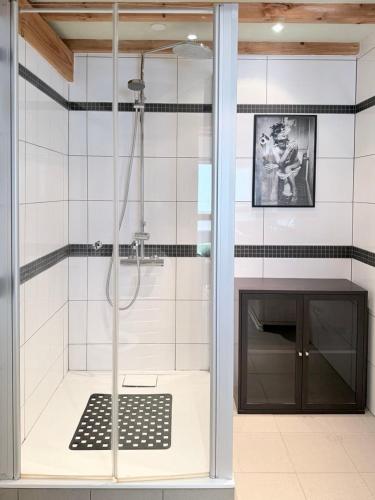 a bathroom with a shower with a glass door at Cozy Cottage - Authentic apartment in Mullerthal in Waldbillig