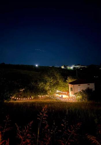 a house with lights on a hill at night at Little fox in Miglianico