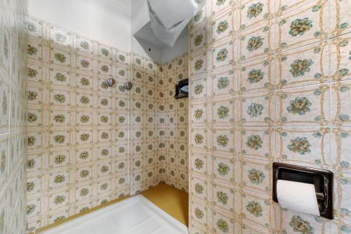 a bathroom with a toilet paper dispenser on a wall at Casa Fenera in Valduggia