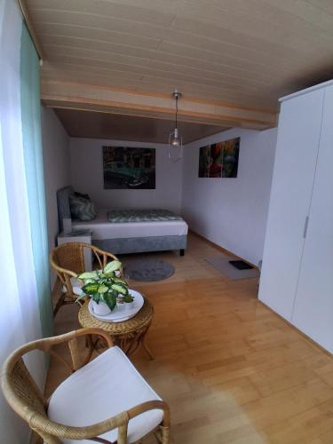 a room with a bed and a table and chairs at Ferienhaus Spengler in Beuren