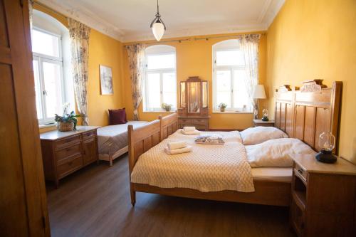 a bedroom with two beds and two windows at Villa Weißbach - Haus Hilda in Flöha
