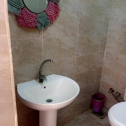 a bathroom with a sink and a mirror on the wall at elwaharesort in Wāsiţ