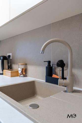 a kitchen sink with a faucet in a kitchen at Noua Suites in Braşov