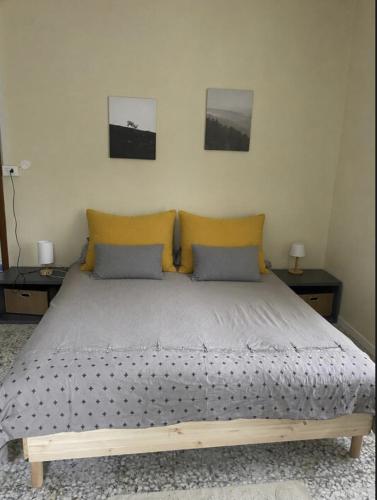 a bedroom with a large bed with two tables at Little fox in Miglianico