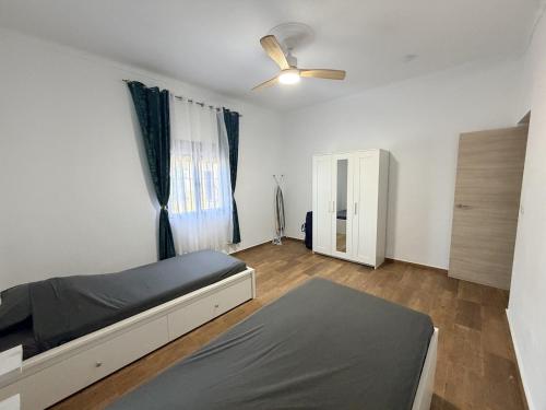 a bedroom with a bed and a ceiling fan at Villa Mia in Marchena