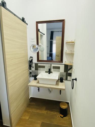 a bathroom with a sink and a mirror at Villa Mia in Marchena