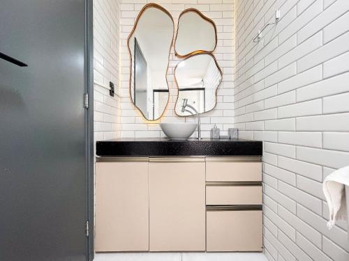 a bathroom with a sink and a mirror at Summer by Hosppedar in Ilha da Restinga