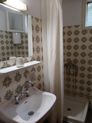 a bathroom with a sink and a shower at Pension Alkistis in Tolo