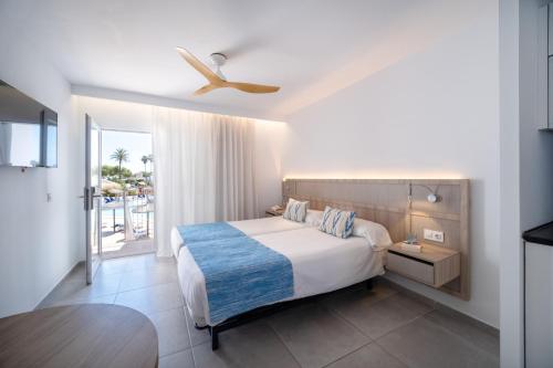 a bedroom with a bed and a view of the ocean at Seaclub Alcudia in Port d'Alcudia