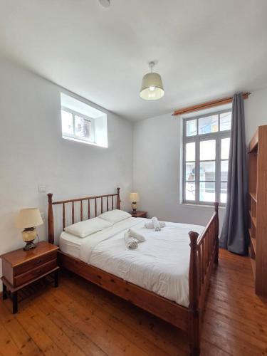 a bedroom with a large bed and a window at Harrys Inn Guesthouse in Larnaca