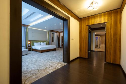 a bedroom with a bed and a large mirror at The District Hotel Najran in Najran