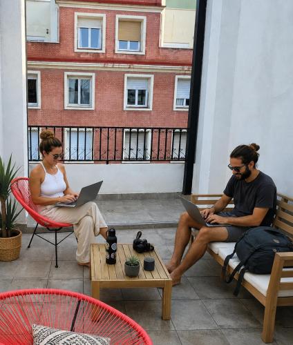 two people sitting on a patio with their laptops at Password to Madrid Gran Vía in Madrid