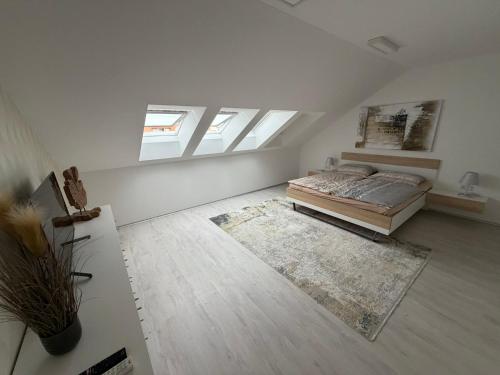 a large white room with a bed and a rug at La Brloh Pardubice in Pardubice