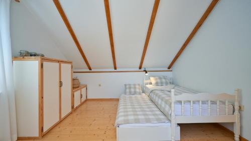 a room with two beds and a cabinet in it at Villa Dobrenic by Villas Guide in Donje Taborište