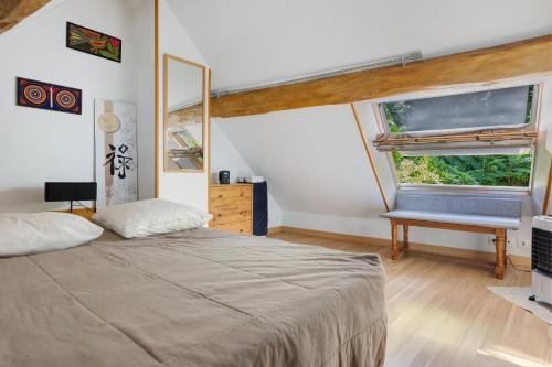 a bedroom with a large bed and a window at Gîte Mélany in Chargé