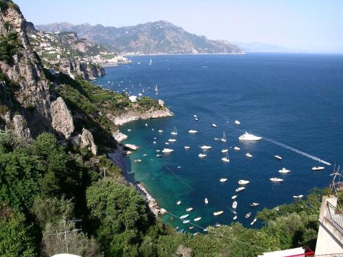 a group of boats in a large body of water at Amalfi 51 con vista mare, giardino e terrazze in Conca dei Marini
