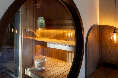 a mirror in a room with a sauna at L'Escale Royale Torcy - Marne la Vallée in Torcy