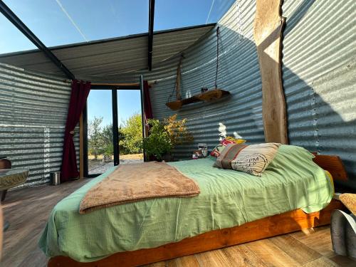 a bedroom with a bed on a deck at La bulle des champs in Champmotteux