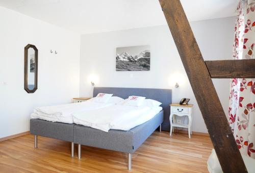 a bedroom with a bed in a room at Hotel Weisses Kreuz in Interlaken