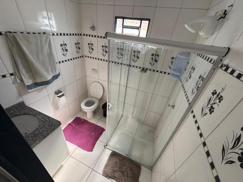 a bathroom with a shower and a toilet at Casa da Santa Marta in Goiás