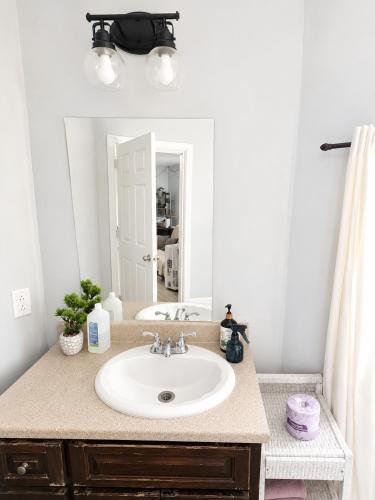 a bathroom with a sink and a mirror at Louisbourg room & Aurora House in Glace Bay