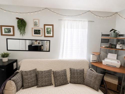 a bedroom with a bed with pillows and a window at Màple room & Aurora House in Glace Bay