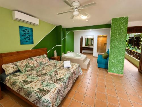 a bedroom with a bed and a bath tub at Kaa Zihil Hotel in Playa del Carmen