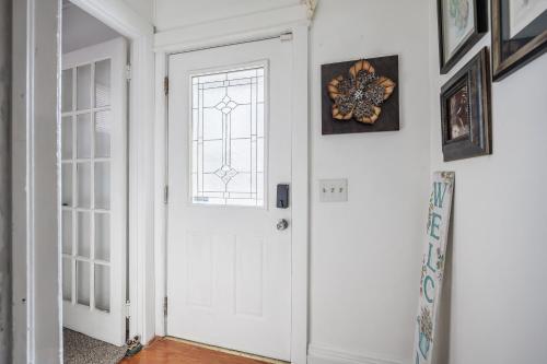 a white door in a hallway with a window at Room B5 Shared bathroom queen Bed Washer Dryer in Rochester