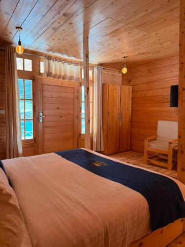 a bedroom with a large bed in a log cabin at Azure Lagoon Resort in Ushu